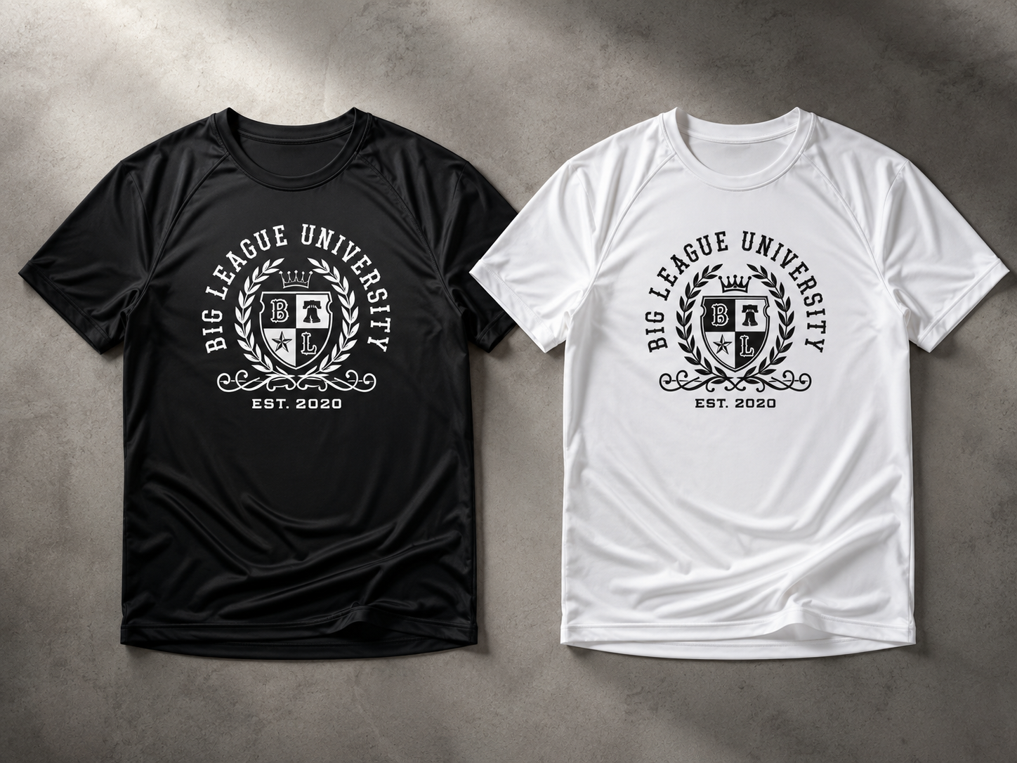Big League University performance dri-fit t-shirts in black and white laid flat for product presentation.